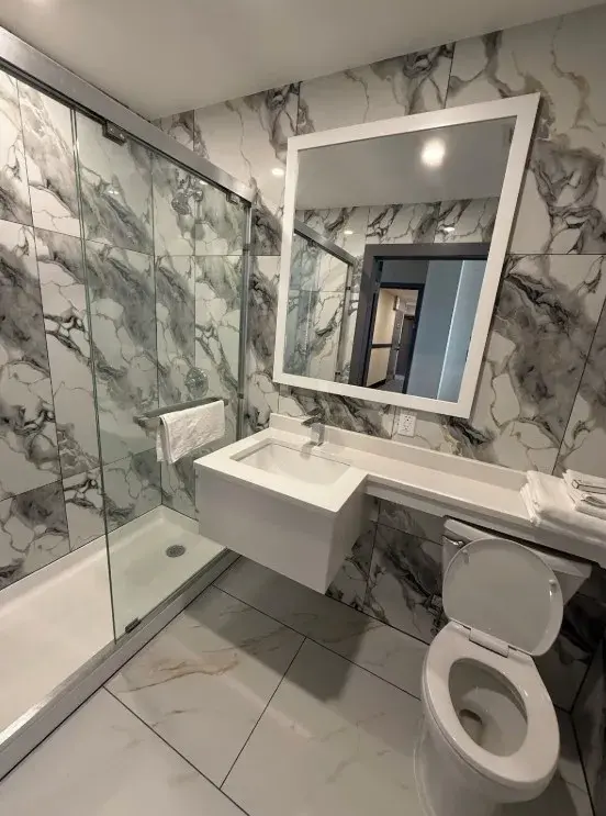 Skylux Hotel private bathroom with glass-enclosed shower